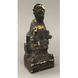 An antique Chinese carved wood painted tomb type figure, worked as a seated dignitary,