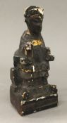 An antique Chinese carved wood painted tomb type figure, worked as a seated dignitary,