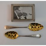 A small silver picture frame and two Georgian silver spoons