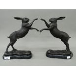 A pair of bronze boxing hares