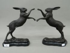 A pair of bronze boxing hares