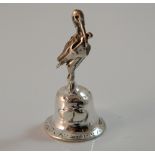 A silver bell mounted with a stork. 4 cm high.