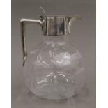 A silver lidded glass claret jug,