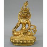 A gilt bronze model of Buddha. 10 cm high.