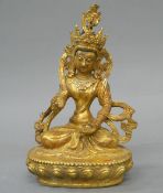 A gilt bronze model of Buddha. 10 cm high.