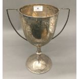 A silver twin handled trophy cup (21.