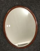 A mahogany framed oval mirror