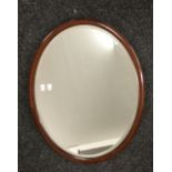 A mahogany framed oval mirror