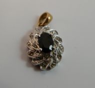 A 9 ct gold diamond and sapphire pendant