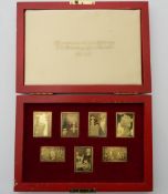 A cased set of silver gilt stamps