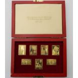 A cased set of silver gilt stamps