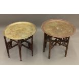 Two Eastern brass topped folding tables