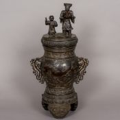 A large 19th century Chinese patinated bronze lidded vase The removable lid formed as a scholarly