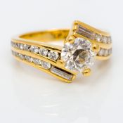 A 18K gold diamond ring The central claw set stone spreading to approximately 0.