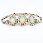 An unmarked white gold or platinum opal and diamond bracelet Centrally set with three cabochon