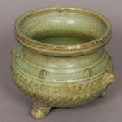 A Chinese celadon glaze porcelain censer Of squat baluster form, with twin mask handles.