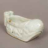 A Chinese porcelain brush washer With allover pale celadon ground. 9 cm long.