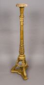 A 19th century carved giltwood torchere Of Corinthian column form, with acanthus carvings,