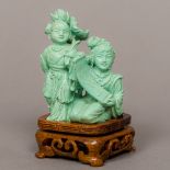 A finely carved Chinese turquoise figural group Formed as a young boy holding a lily with a girl