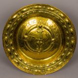 An 18th century brass alms dish Of typical circular dished form,