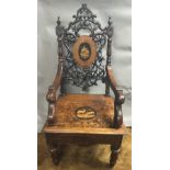 A 19th century Black Forest carved and penwork musical open armchair The pierced carved back