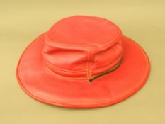 A red leather wide brimmed hat The interior stamped Hatquarters U S A by Hensce. Approximate.