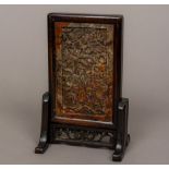 A small late 19th century Chinese carved soapstone panel inset table screen The panel carved with a