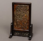 A small late 19th century Chinese carved soapstone panel inset table screen The panel carved with a