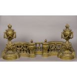 An ornate 19th century brass fire curb Each end surmounted with a flaming urn with floral swags and