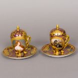 A pair of 19th century Vienna porcelain covered chocolate cups and saucers One painted with a young