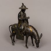 A Chinese patinated bronze model of a bearded figure on horseback Modelled wearing a hat holding a