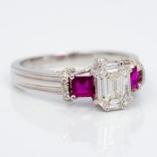 An 18 ct white gold diamond and ruby trilogy ring Set with approximately 1 carat of diamonds.