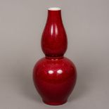 A Chinese porcelain double gourd vase With allover sang de boeuf glaze,