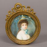 A 19th century portrait miniature on ivory Depicting a young girl wearing a hat and blue neck scarf,