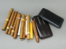 Two leather cigar cases And a small quantity of cigars.