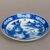 A Chinese porcelain blue and white dish Decorated to the centre with figures and pagodas amongst a