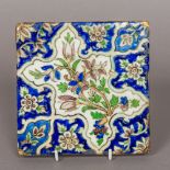 An antique Iznik tile Typically decorated with floral motifs. 16.25 cm square.