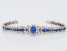 An Art Deco unmarked white gold or platinum diamond and sapphire bracelet The central flowerhead