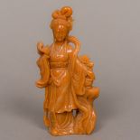 A light brown Chinese hardstone figural carving Formed as young woman standing beside a flowering