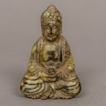 A Chinese carved hardstone Buddha Modelled seated in the lotus position holding a gourd,