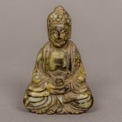 A Chinese carved hardstone Buddha Modelled seated in the lotus position holding a gourd,