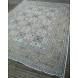 A Persian wool carpet Centred with floral motif filled geometric panels. 315 x 260 cm.