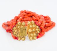 An five strand coral bead necklace Set with an 18 ct filigree gold clasp. Approximately 40 cm long.