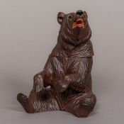 A carved wooden Black Forest bear form box The hinged head enclosing the vacant interior.