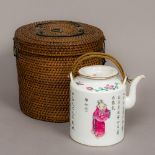 A 19th century Chinese famille rose porcelain teapot Decorated in the round with figures amongst