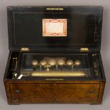 A 19th century Swiss music box The ebonised and line inlaid burr walnut case enclosing the