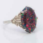 An unmarked white gold or platinum black opal and diamond ring The claw set cabochon opal above the