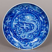 A Chinese blue and white porcelain dish Decorated with dragons chasing flaming pearls,