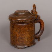 A 19th century Scandinavian burrwood lidded tankard Of typical form with loop handle and animal