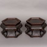 A pair of 19th century Chinese carved wooden urn stands Each of hexagonal form,
